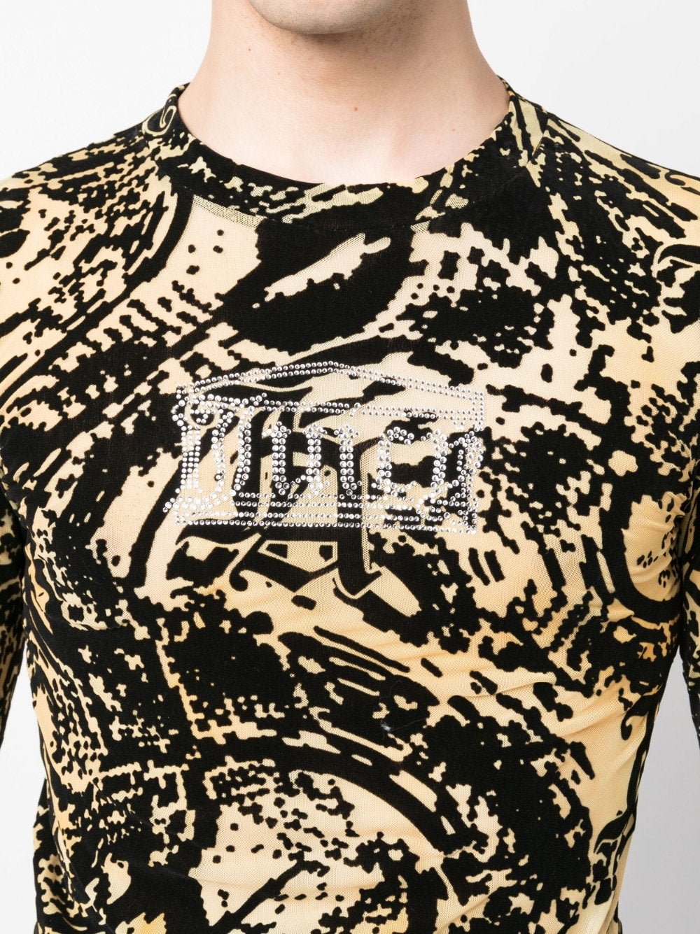 Close-up van de doorschijnende mesh met zwarte flockprint en het Juicy-logo in strass