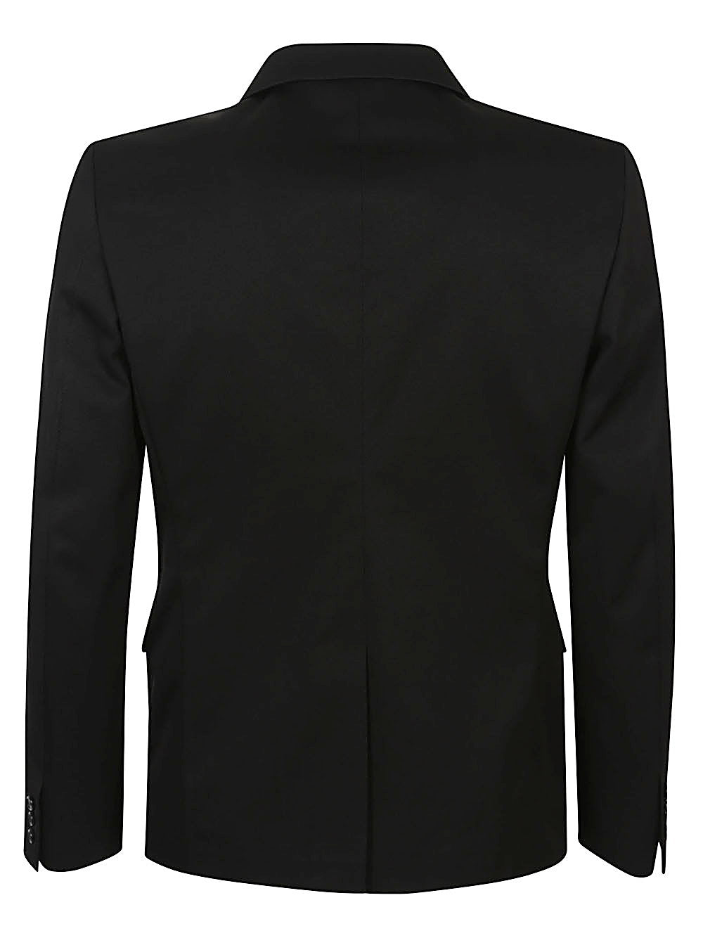 Achterkant van het zwarte Comme des Garçons colbert met zijsplitten