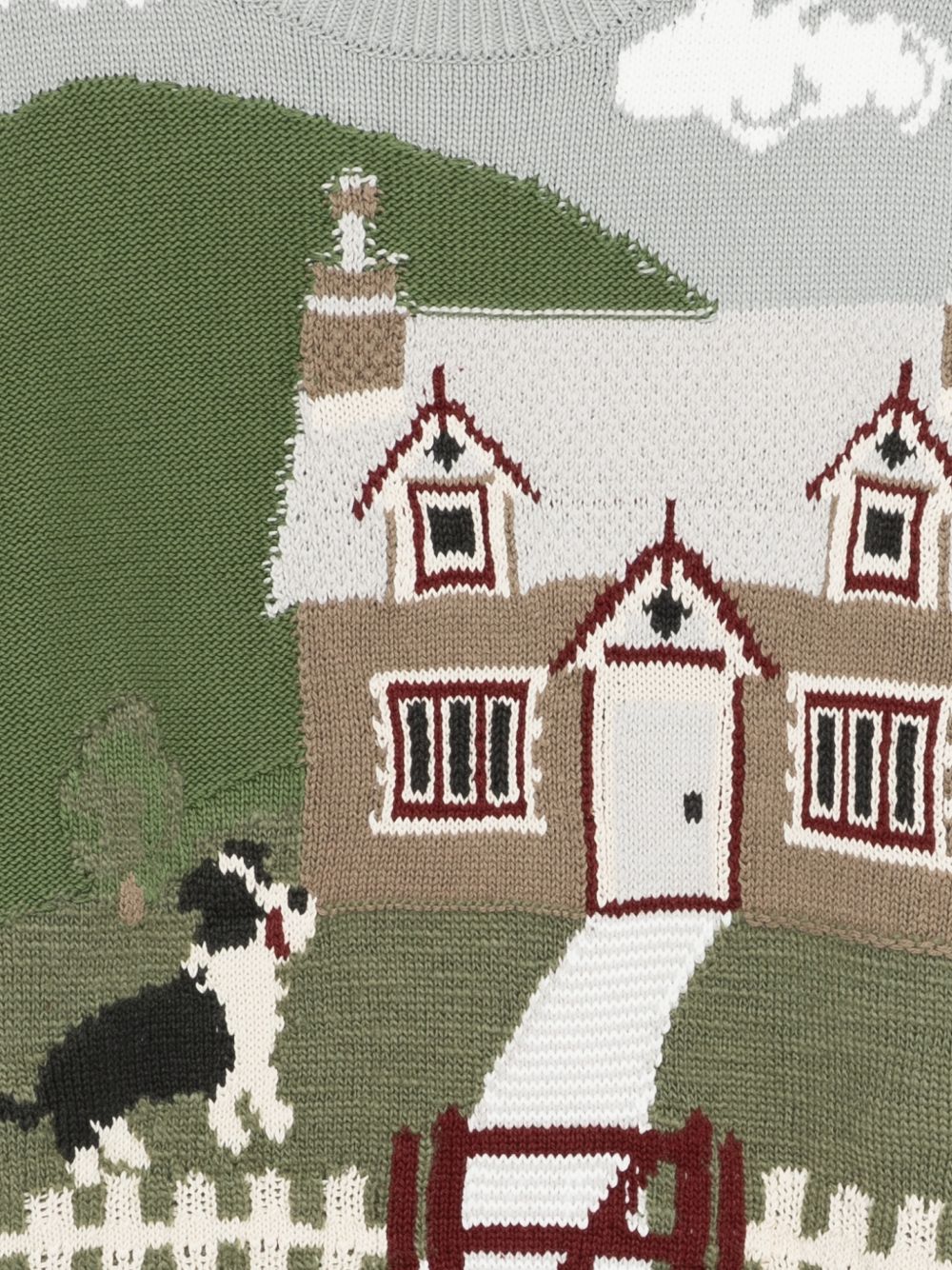 Achterkant van de intarsia trui met rood schuurtje, ganzen en hekwerk
