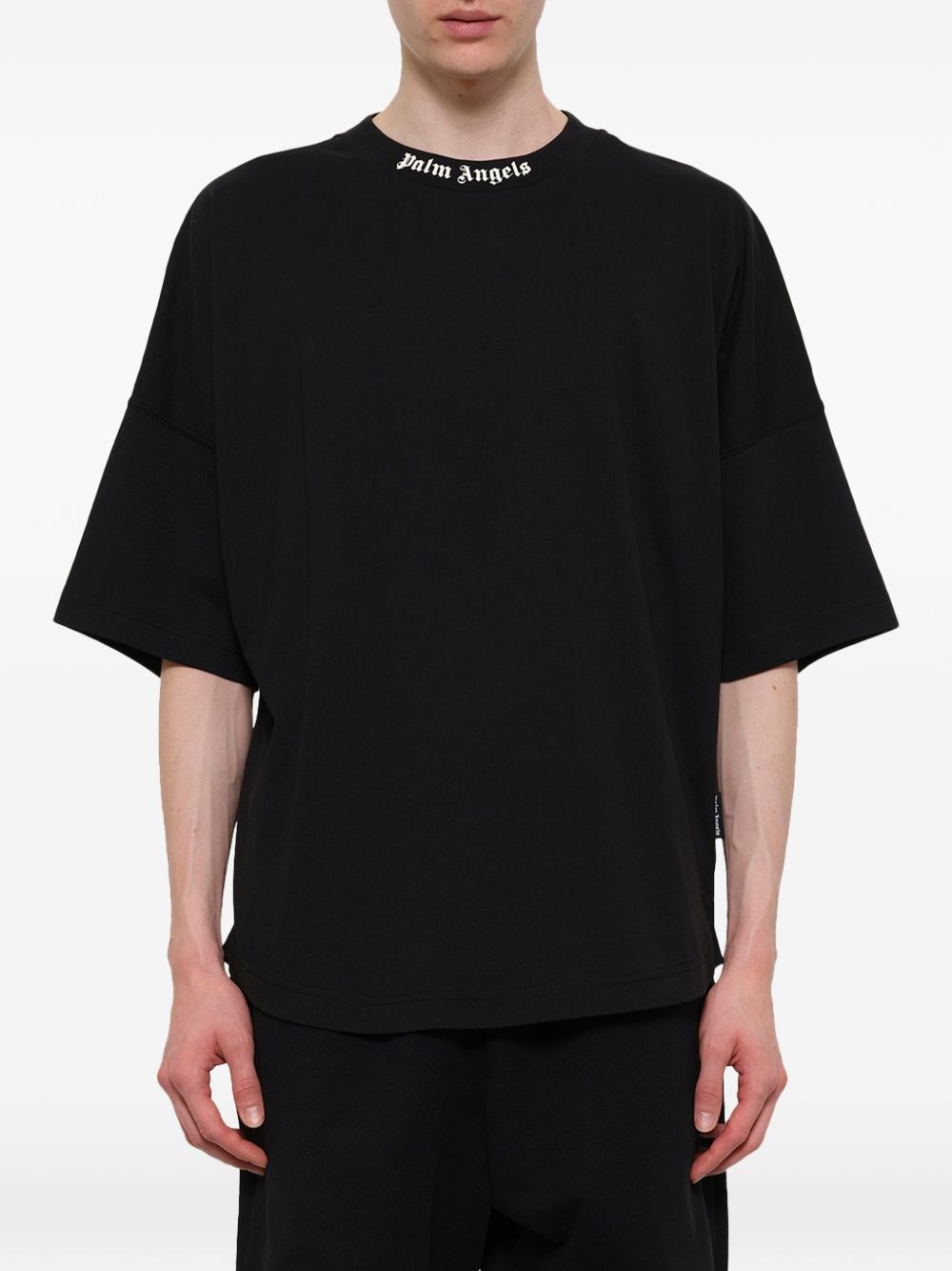 Close-up van de Palm Angels-logoprint op de zwarte T-shirt